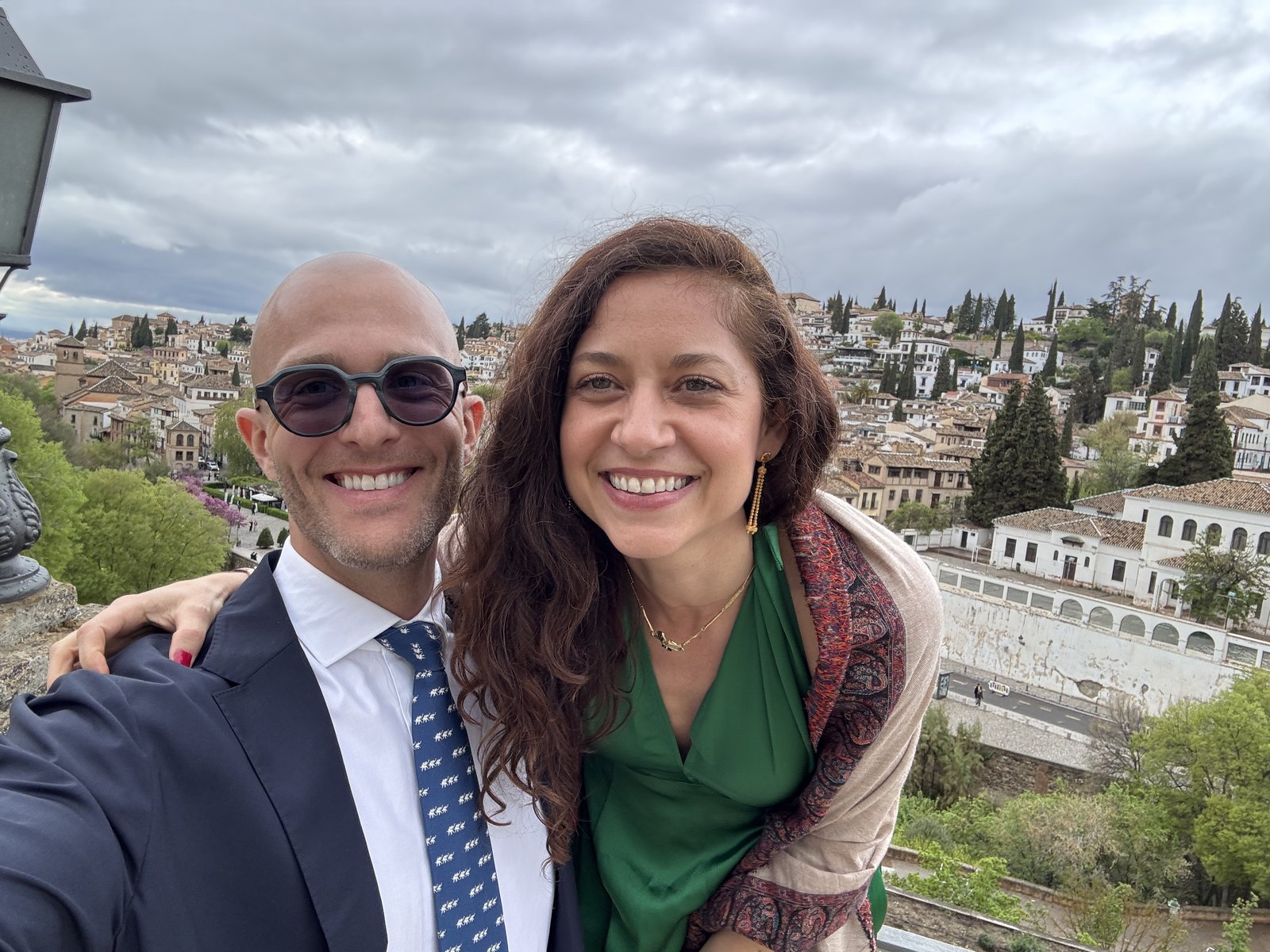Thomas and Teri smiling above the white houses of Granada